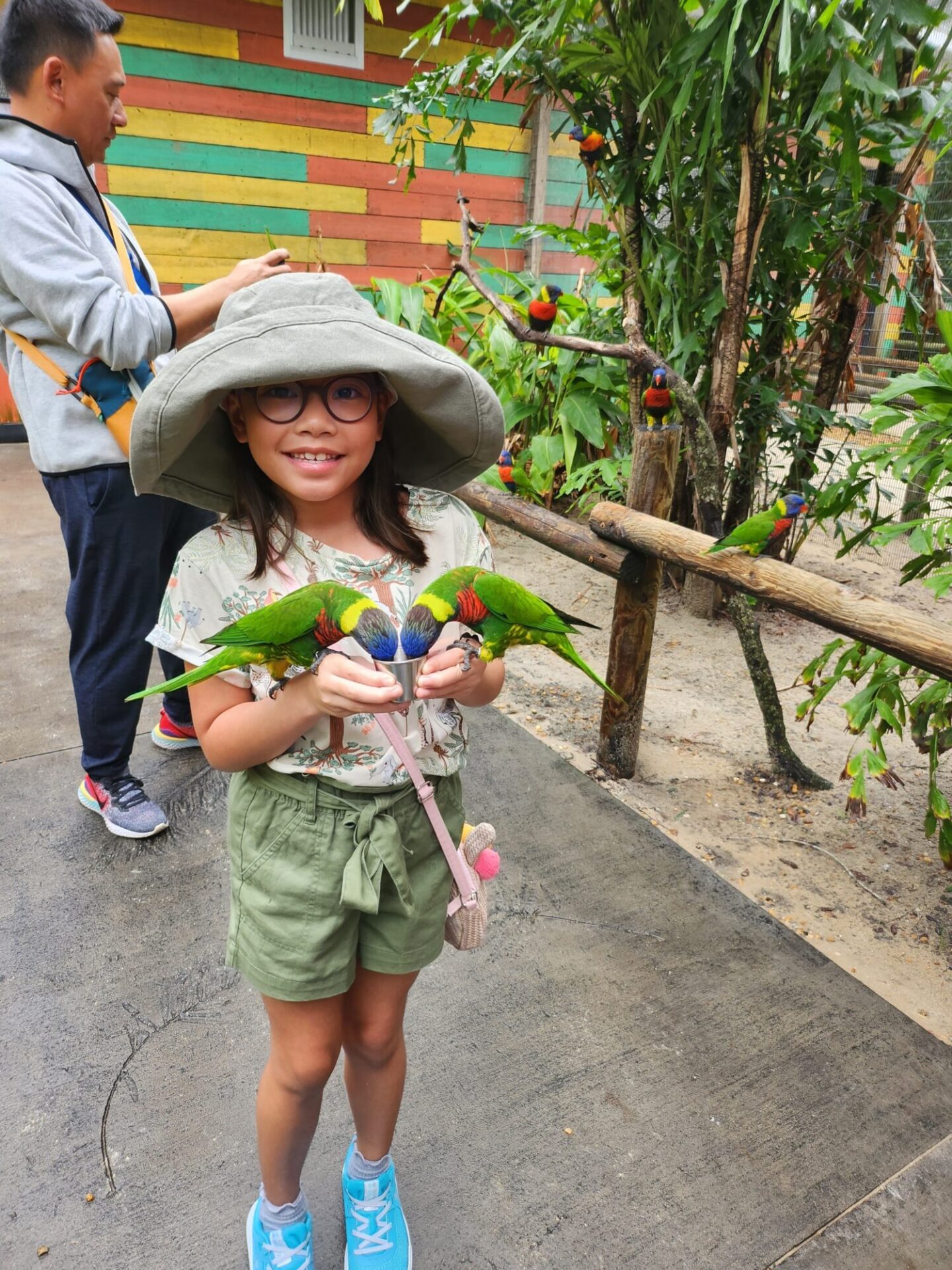 Girl with parrots in her hands