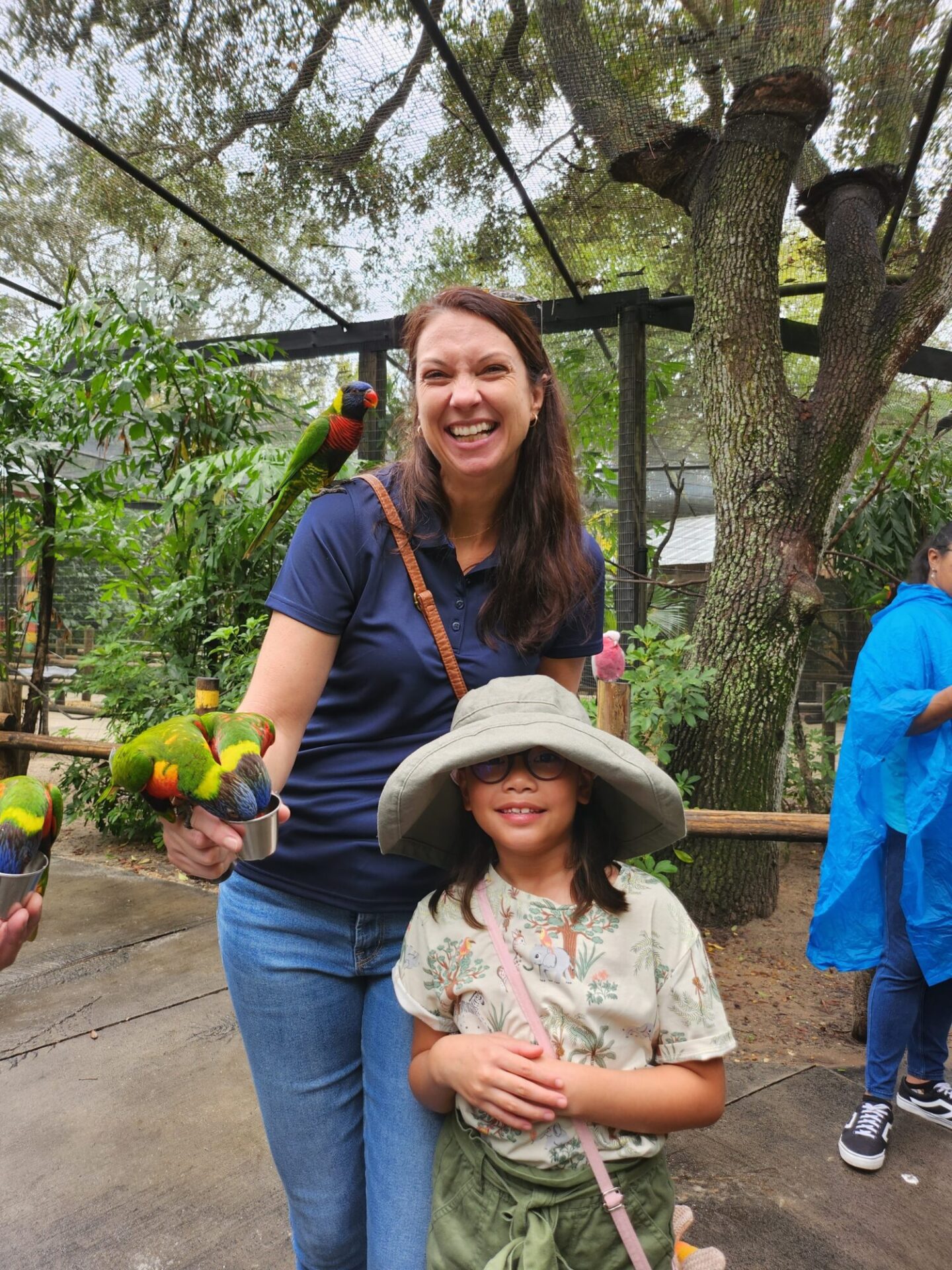 Woman with parrots and little girl