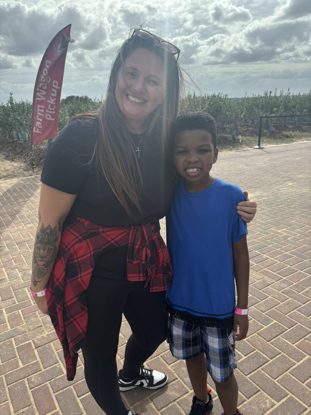 Boy with a blue shirt hugging a woman