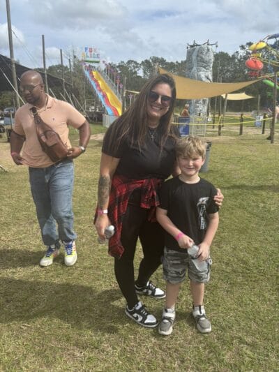 women in a black shirt hugging a boy