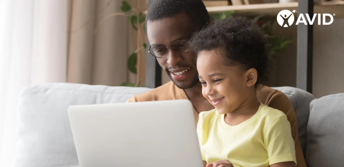 Father and son watiching an online class