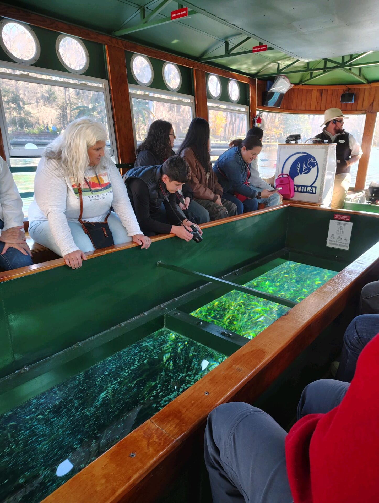 people looking a big fish from a boat