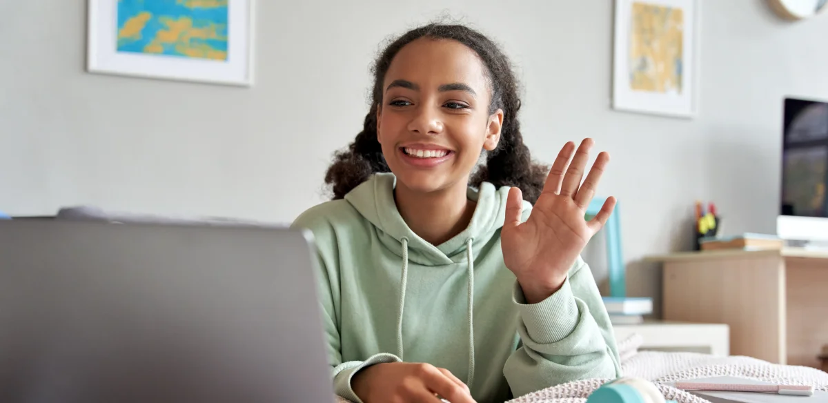 Student waiving at her online class
