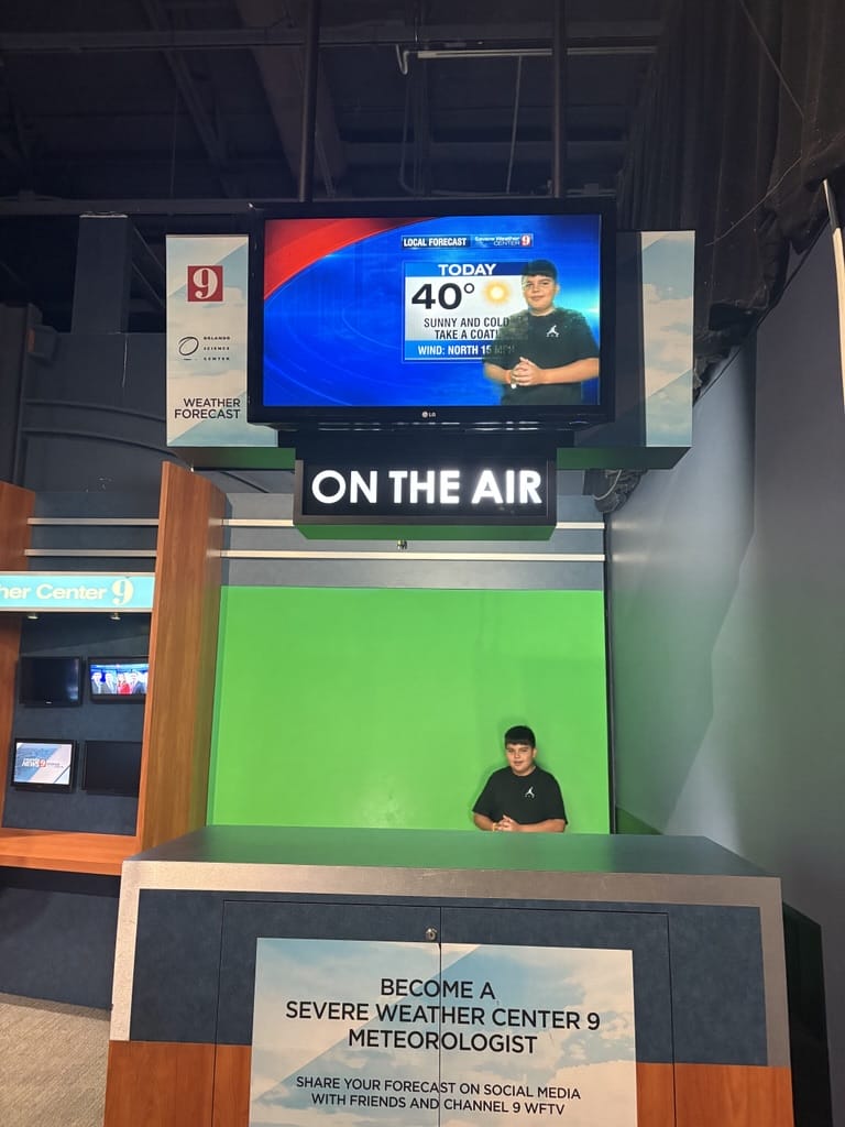 student in the tv news attraction in the museum