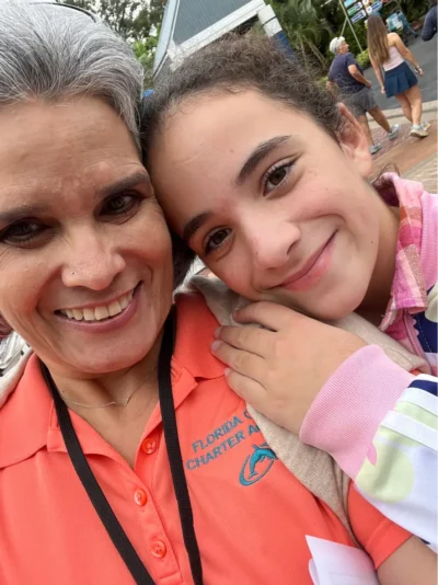 Girl with teacher in the zoo