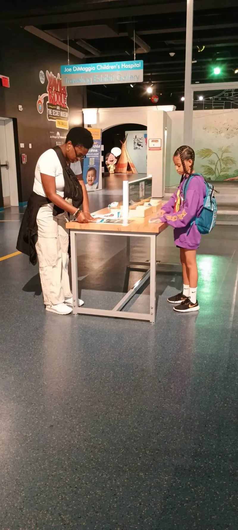 mom and girl playing at the museum