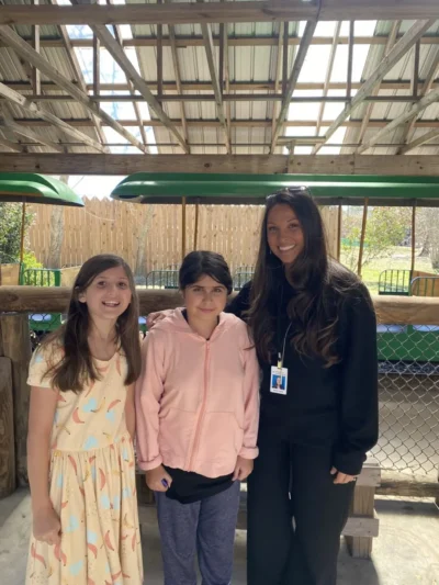 teacher and girls in the zoo