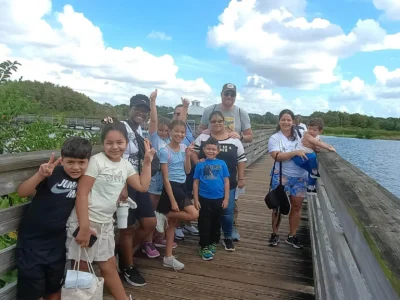 A group of people standing next to a lake