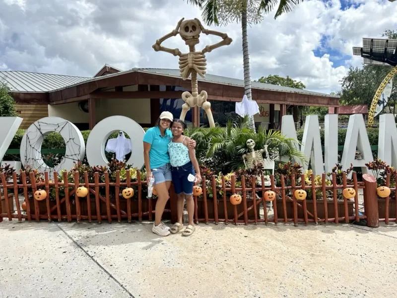 Girls in the zoo with october decoration